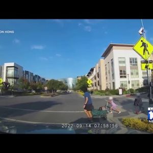 A little girl is almost hit by a car while trying to cross the street