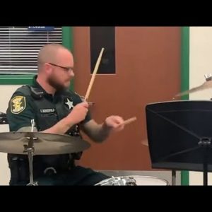 St. Johns County Deputy Schoenfield drums at a hurricane shelter