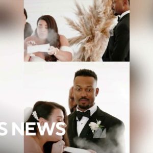 Bride makes wedding guests laugh by blowing dust off of wedding vows