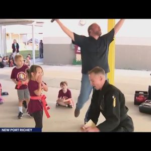 Little girl karate chops wood panel at Florida elementary school