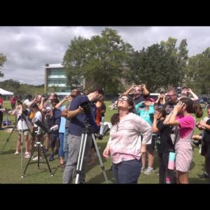 People gather to watch the eclipse at UNF Saturday